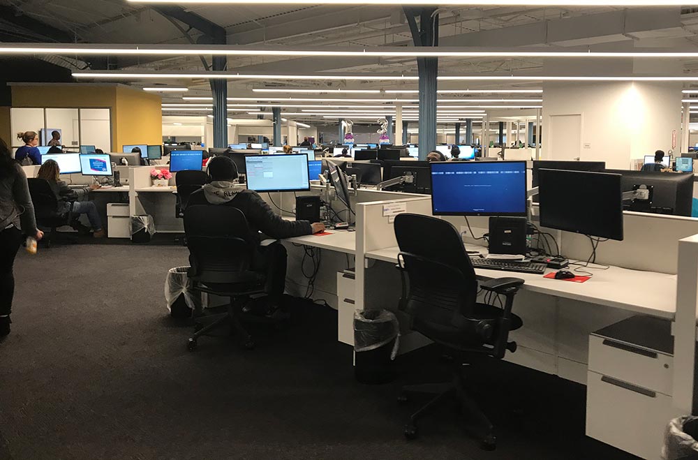 Image of customer service center with agents taking calls in a corporate setting